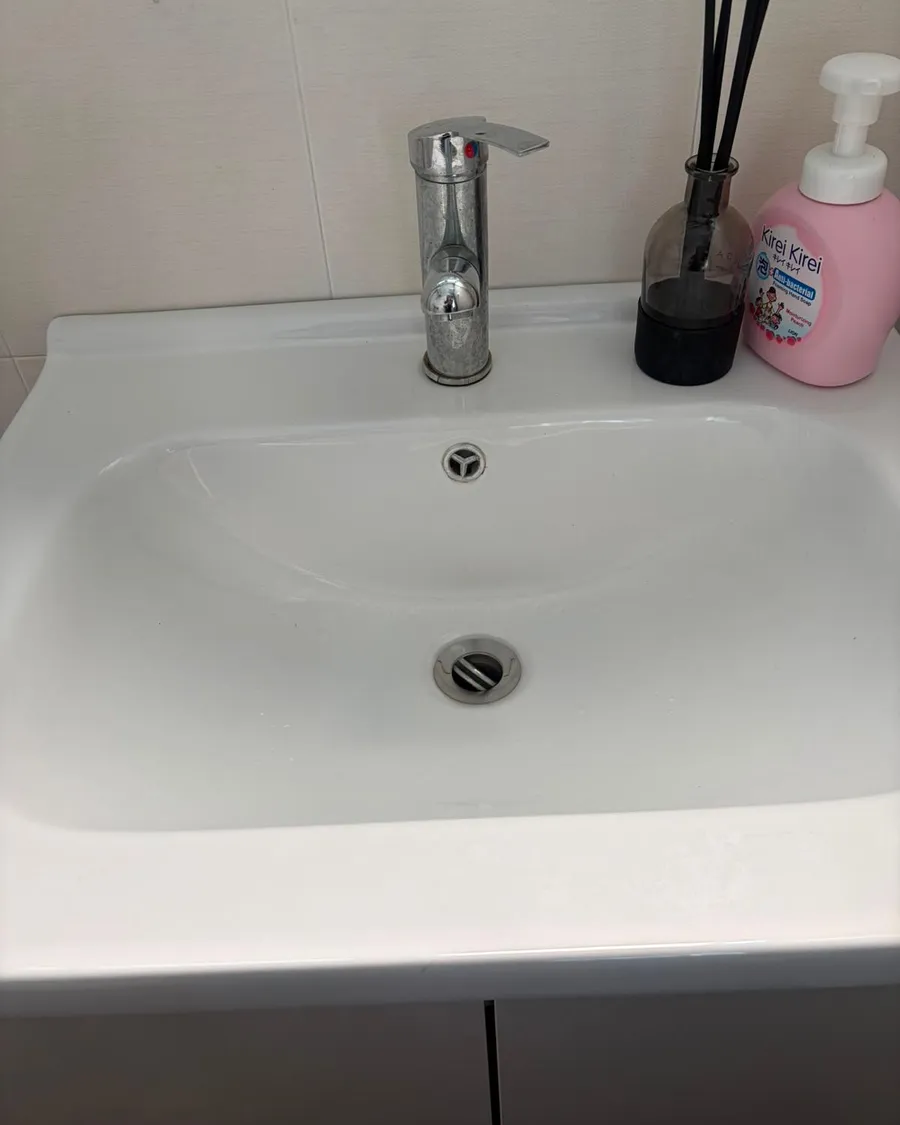 Chrome basin mixer tap installed on a white basin in an HDB bathroom in Singapore